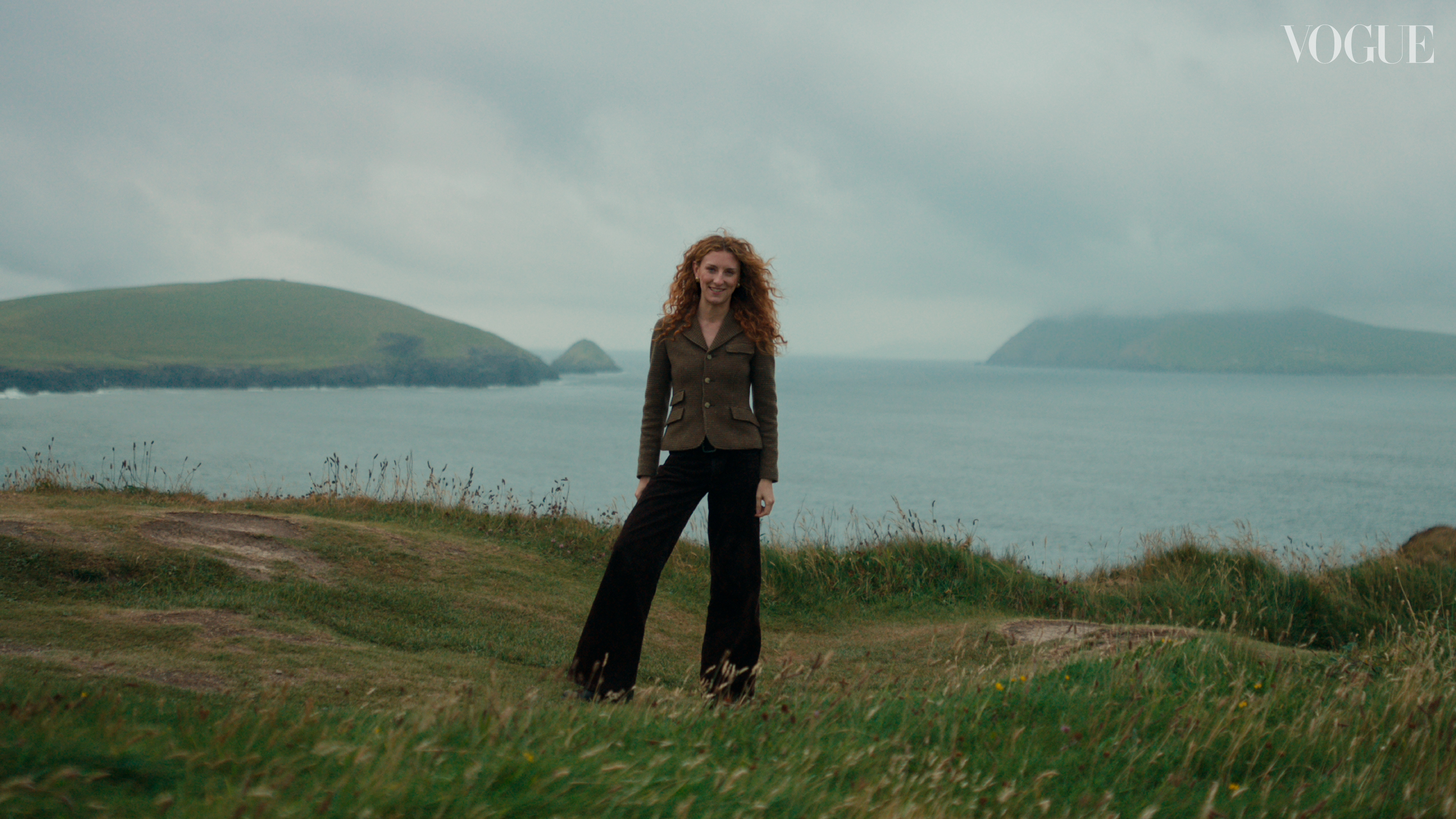 Woman standing over grass in county kerry in Ireland wearing irish craft