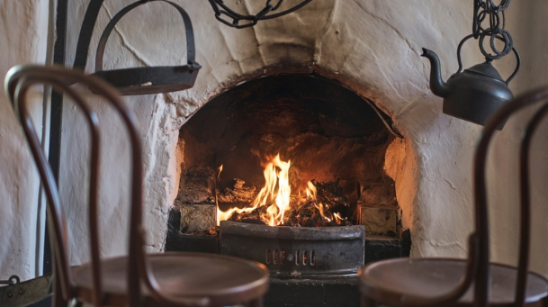 Two chairs in front of a fireplace in an Irish home.